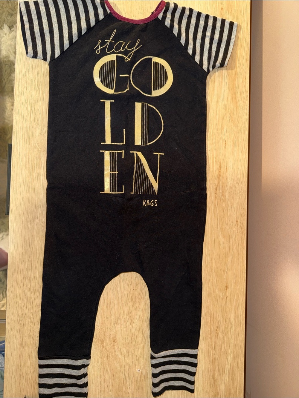 Rags to Raches Black One-Piece with Gold Lettering and Gray Stripes